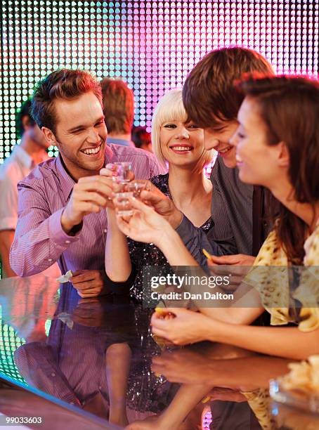 young people drinking tequila shots in a nightclub - spirit 32 ストックフォトと画像