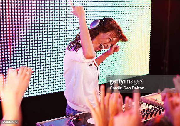 young female dj at record decks in nightclub - disc jockey stock pictures, royalty-free photos & images