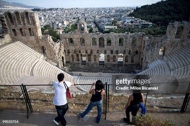 Tourists look at the ancient Greek Herodes Atticus theatre, one of the city's modern landmarks on May 11, 2010 in central Athens. Greece's debt...