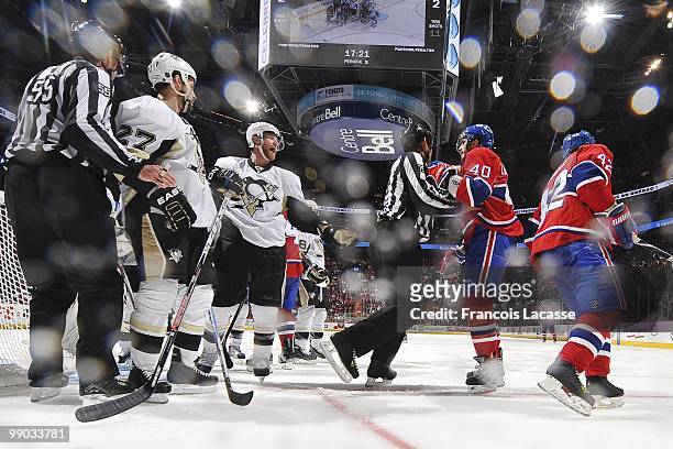Maxim Lapierre of Montreal Canadiens talks with the linesman in front of Craig Adams of the Pittsburgh Penguins in Game Four of the Eastern...