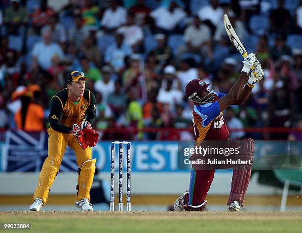 Kieron Pollard of the West Indies hits out a Brad Haddin looks on during the ICC World Twenty20 Super Eight match between the West Indies and...