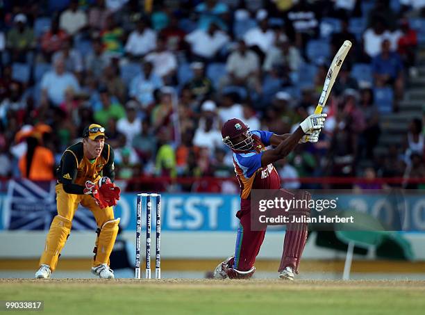 Kieron Pollard of the West Indies hits out a Brad Haddin looks on during the ICC World Twenty20 Super Eight match between the West Indies and...