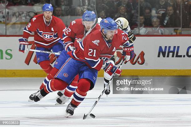Brian Gionta of Montreal Canadiens skates with the puck with teammate Travis Moen in Game Four of the Eastern Conference Semifinals against the...