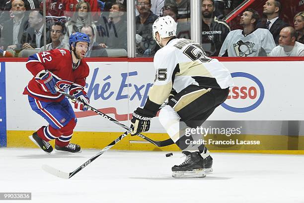 Dominic Moore of the Montreal Canadiens skates with the puck in front of Sergei Gonchar of the Pittsburgh Penguins in Game Four of the Eastern...