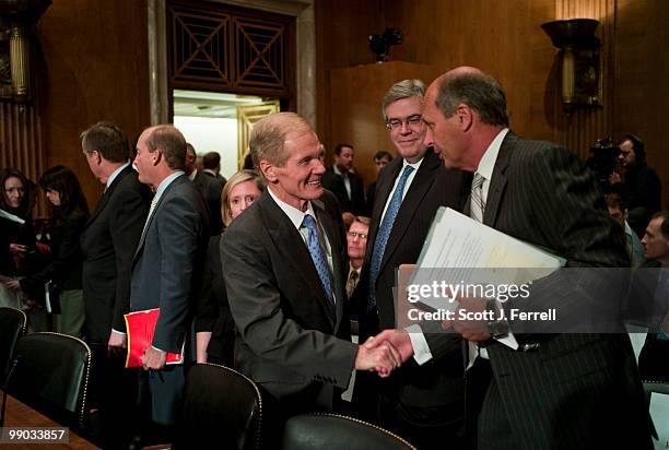 May 11: Sen. Bill Nelson, D-Fla., shakes hands with Tim Probert, president of global business lines and the chief health, safety and environmental...