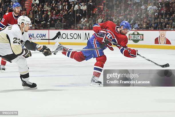 Marc-Andre Bergeron of Montreal Canadiens takes a shot in front of Alexei Ponikarovsky of the Pittsburgh Penguins in Game Four of the Eastern...