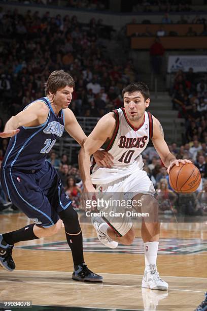 Carlos Delfino of the Milwaukee Bucks drives the ball against Kyle Korver of the Utah Jazz on March 12, 2010 at the Bradley Center in Milwaukee,...