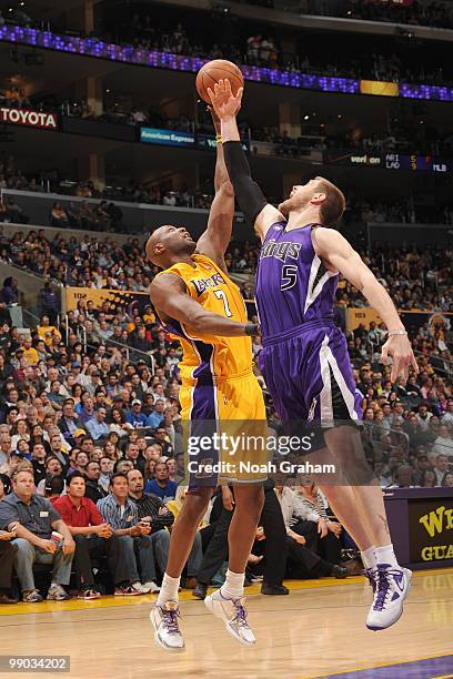 Lamar Odom of the Los Angeles Lakers tips the ball against Andres Nocioni of the Sacramento Kings at Staples Center on April 13, 2010 in Los Angeles,...