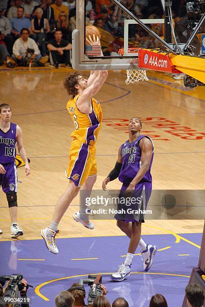 Pau Gasol of the Los Angeles Lakers makes a dunk against Jason Thompson of the Sacramento Kings at Staples Center on April 13, 2010 in Los Angeles,...