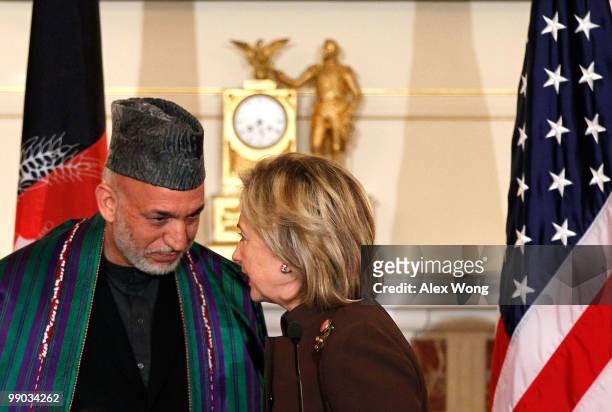 Secretary of State Hillary Rodham Clinton chats with Afghan President Hamid Karzai during a reception for Karzai at the State Department May 11, 2010...