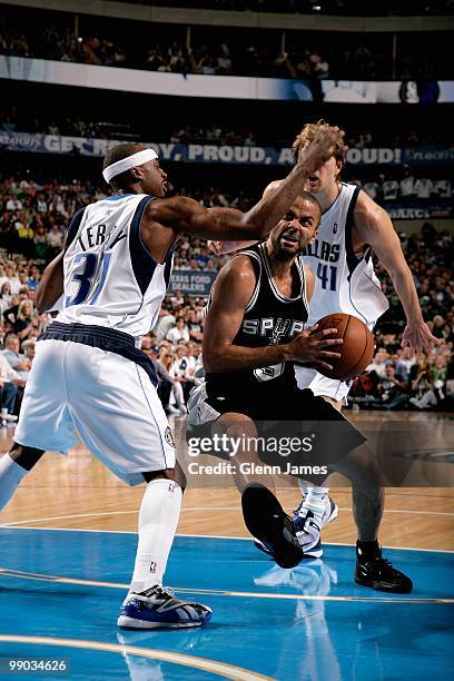 Tony Parker of the San Antonio Spurs drives to the basket against Jason Terry and Dirk Nowitzki of the Dallas Mavericks in Game Five of the Western...