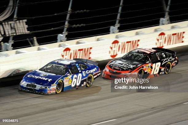Carl Edwards, driver of the Copart Ford, leads Kyle Busch, driver of the Z-Line Designs / Racing for Kids Toyota, during the NASCAR Nationwide series...