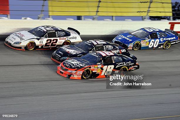 Brad Keselowski, driver of the Ruby Tuesday Dodge, leads Justin Allgaier, driver of the Verizion Wireless Dodge, Kyle Busch, driver of the Z-Line...