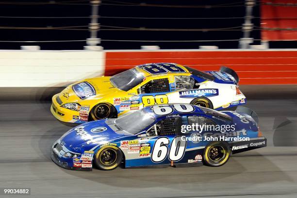 Carl Edwards, driver of the Copart Ford races against Jamie McMurray, driver of the Hellmann's Chevrolt, during the NASCAR Nationwide series Royal...