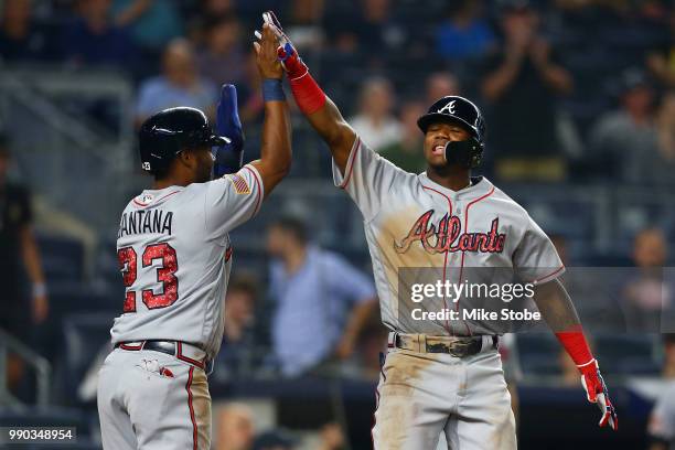 Ronald Acuna Jr. #13 of the Atlanta Braves celebrate with Danny Santana after hitting a 2-run game winning home run in the top of the eleventh inning...