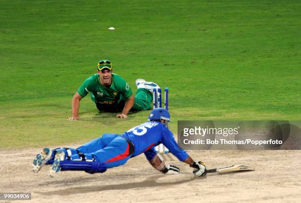 De Villiers of South Africa runs out Shinwari Samiullah of Afghanistan during The ICC World Twenty20 Group C Match between South Africa and...