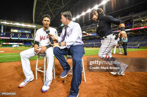 The Monkey arrives to pie in the face Yadiel Rivera of the Miami Marlins after getting a walk off single in the tenth inning against the at Marlins...