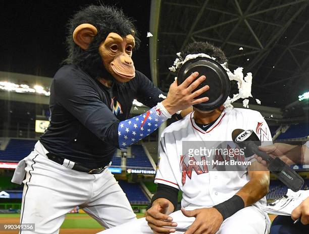 The Monkey arrives to pie in the face Yadiel Rivera of the Miami Marlins after getting a walk off single in the tenth inning against the at Marlins...
