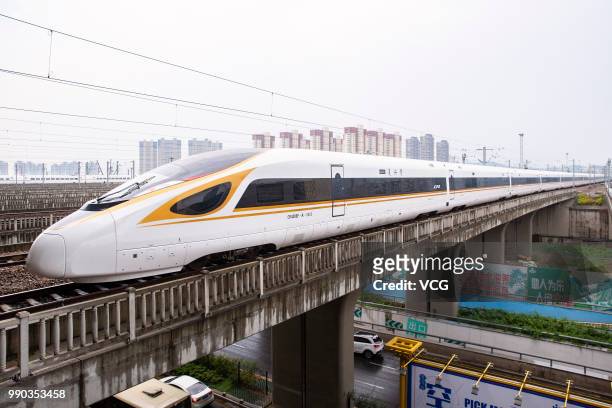 No. G118 Fuxing bullet train runs out of Nanjing South Railway Station on July 1, 2018 in Nanjing, Jiangsu Province of China. New longer Fuxing...