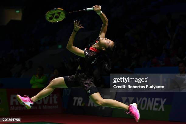 Fitriani of Indonesia competes against Ratchanok Intanon of Thailand during Women's Singles Round 1 on day one of the Blibli Indonesia Open at Istora...