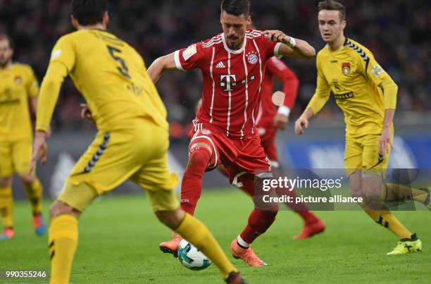 Munich's Sandro Wagner and Grossaspach's Julian Leist vie for the ball during the soccer friendly match between FC Bayern Munich and SG Sonnenhof...