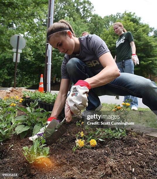 Shalee Lehning of the Atlanta Dream helps plant flowers at Collier Heights Park on May 11, 2010 in Atlanta, Georgia. NOTE TO USER: User expressly...