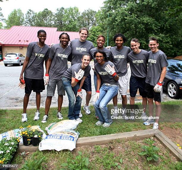 Members of the Atlanta Dream pose before planting flowers at Collier Heights Park on May 11, 2010 in Atlanta, Georgia. NOTE TO USER: User expressly...