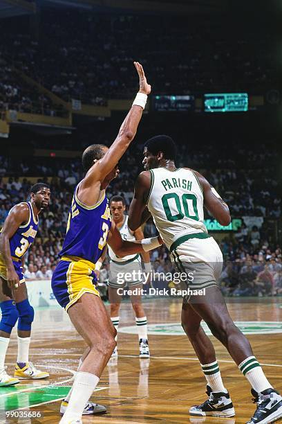 Robert Parish of the Boston Celtics makes a move against Kareem Abdul-Jabbar of the Los Angeles Lakers during the 1987 NBA Finals at the Boston...