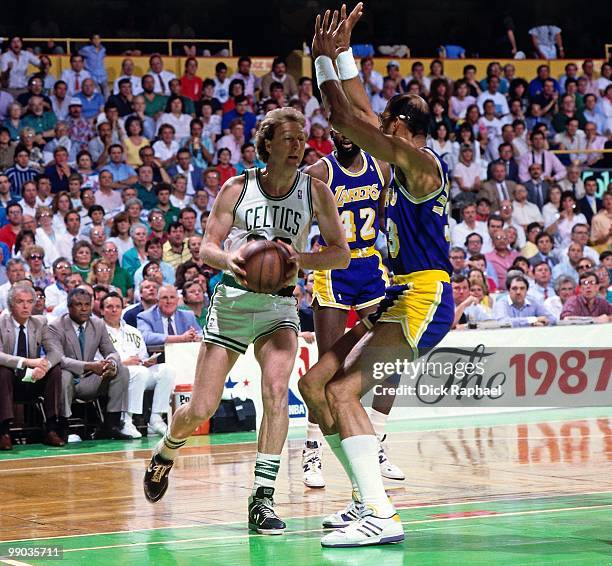 Larry Bird of the Boston Celtics drives to the basket against Kareem Abdul-Jabbar of the Los Angeles Lakers during the 1987 NBA Finals at the Boston...