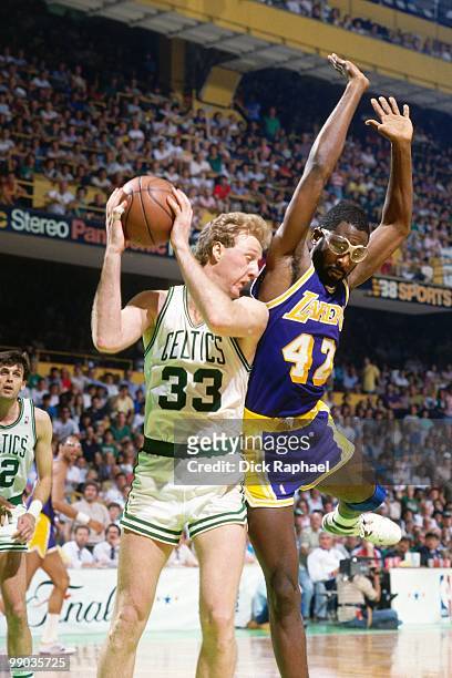 Larry Bird of the Boston Celtics rebounds against James Worthy of the Los Angeles Lakers during the 1987 NBA Finals at the Boston Garden in Boston,...
