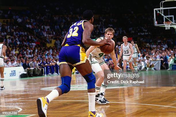 Magic Johnson of the Los Angeles Lakers moves the ball up court against Danny Ainge of the Boston Celtics during the 1987 NBA Finals at the Boston...