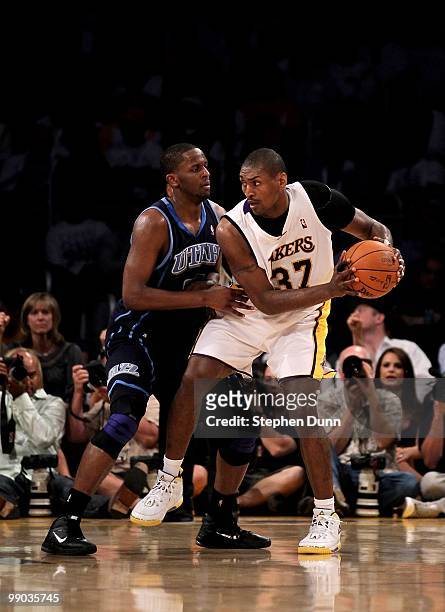 Ron Artest of the Los Angeles Lakers controls the ball against C.J. Miles of the Utah Jazz during Game One of the Western Conference Semifinals of...
