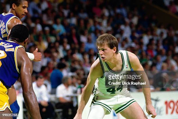 Danny Ainge of the Boston Celtics defends against Magic Johnson of the Los Angeles Lakers during the 1987 NBA Finals at the Boston Garden in Boston,...