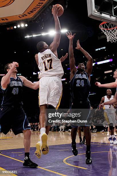 Andrew Bynum of the Los Angeles Lakers shoots over Paul Millsap and Kosta Koufos of the Utah Jazz during Game One of the Western Conference...