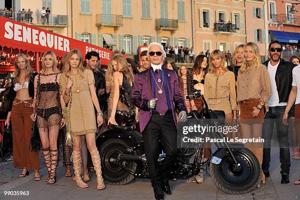 Karl Lagerfeld poses with models during the Chanel Cruise Collection Presentation on May 11, 2010 in Saint-Tropez, France.