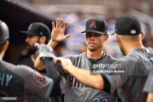 Clay Buchholz of the Arizona Diamondbacks in the dugout with teammates during the game against the Miami Marlins at Marlins Park on June 26, 2018 in...