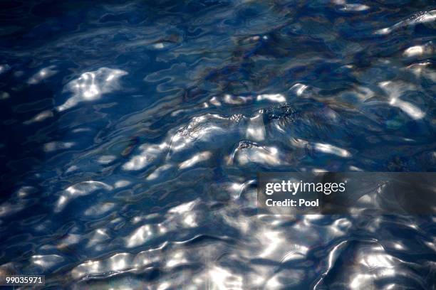 Oil is seen in the water from the bridge of the supply vessel Joe Griffin at the site of the Deepwater Horizon oil spill May 11, 2010 off the coast...