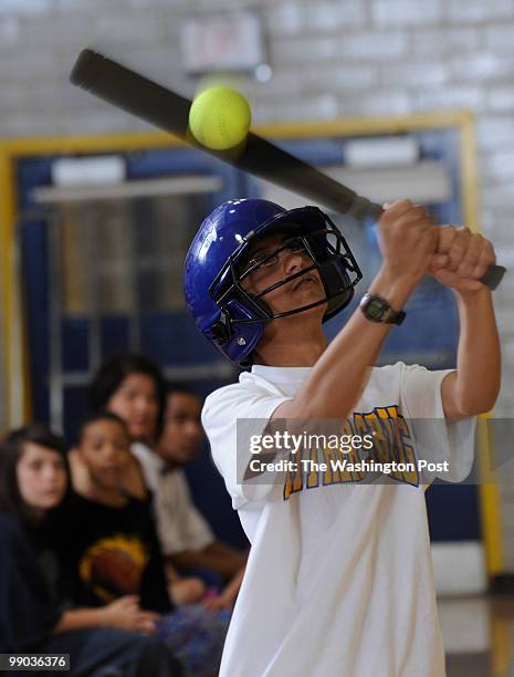 May 1: Gaithersburg High School student Siram Soundararajan gets a hit during the corollary softball game at Gaithersburg High School on Saturday,...