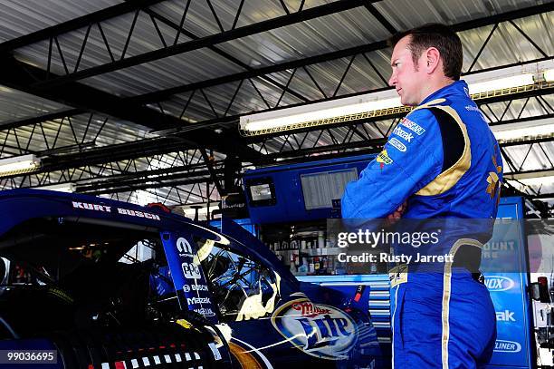 Kurt Busch, driver of the Miller Lite Dodge, stands next to his car in the garage during practice for the NASCAR Sprint Cup Series Showtime Southern...