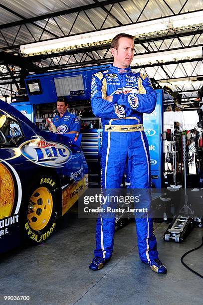 Kurt Busch, driver of the Miller Lite Dodge, stands next to his car in the garage during practice for the NASCAR Sprint Cup Series Showtime Southern...