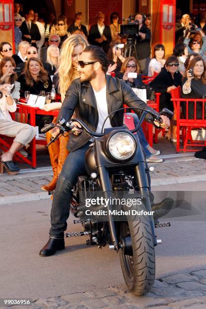 Georgia Jagger and Seb ride on a Harley Davidson at the Chanel Cruise Collection Presentation on May 11, 2010 in Saint-Tropez, France.