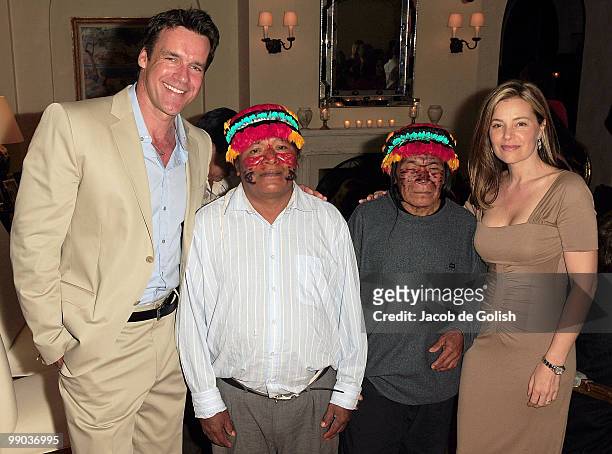 Nanci Chambers and Husband David James Elliott pose for a photo with the Amazon People during the Amazon Watch Fundrasier on May 7, 2010 in Los...
