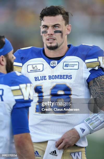 Bryan Bennett of the Winnipeg Blue Bombers watches the replay screen against the Hamilton Tiger-Cats in a CFL game at Tim Hortons Field on June 29,...