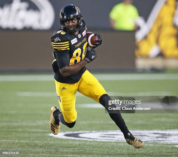 Terrence Toliver of the Hamilton Tiger-Cats runs with the ball against the Winnipeg Blue Bombers in a CFL game at Tim Hortons Field on June 29, 2018...