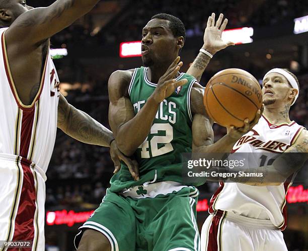 Tony Allen of the Boston Celtics tries looks to pass between Shaquille O'Neal and Delonte West of the Cleveland Cavaliers in Game Five of the Eastern...
