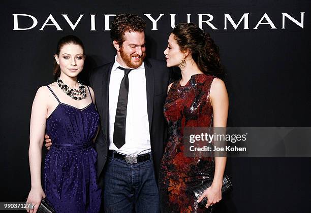 Actresses Michelle Trachtenberg and Emmy Rossum pose for a photo with Evan Yurman the 30th Anniversary celebration cocktail reception with Rebirth of...
