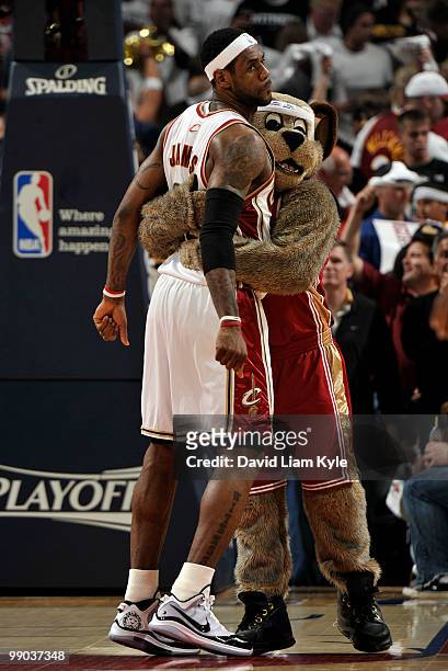 LeBron James of the Cleveland Cavaliers receives a hug from mascot Moondog before the start of Game Five of the Eastern Conference Semifinals against...