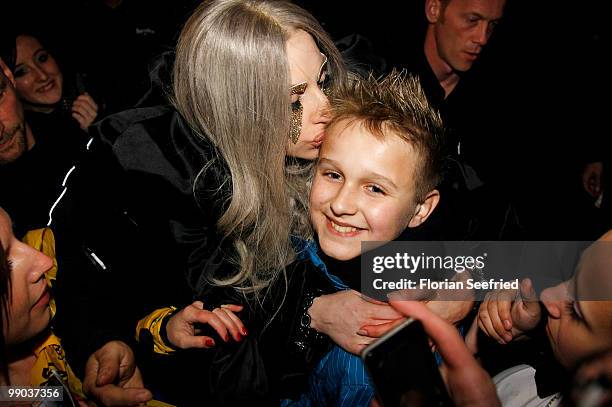 Lady Gaga kisses a fan during she leaves the O2 World after her concert on May 11, 2010 in Berlin, Germany.