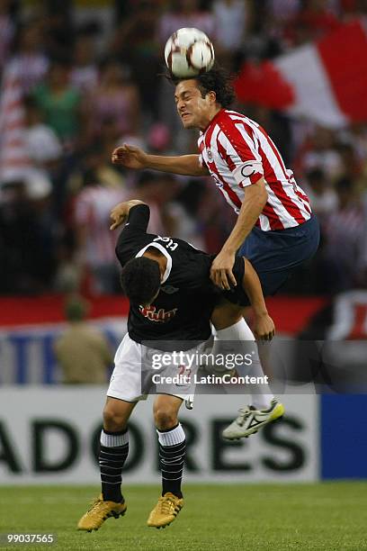 Hector Reynoso of Mexico's Chivas vies for the ball with Rodolfo Gamarra of Paraguay's Libertad during their Santander Libertadores Cup match at...