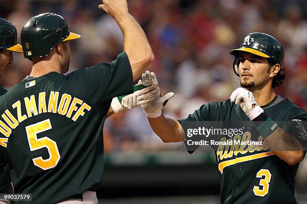 Eric Chavez of the Oakland Athletics celebrates his two run homerun with Kevin Kouzmanoff against the Texas Rangers on May 11, 2010 at Rangers...